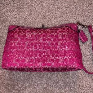 Hot pink coach wristlet.